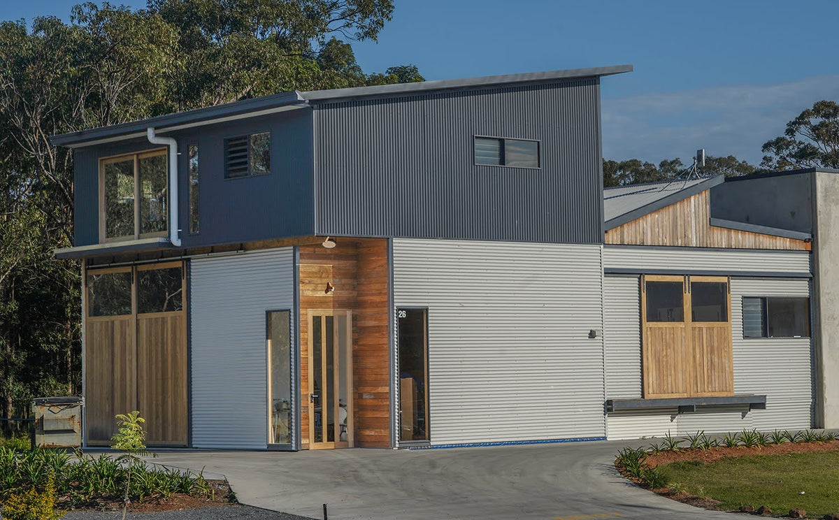 Modern house with a combination of gray, white, and wood exterior